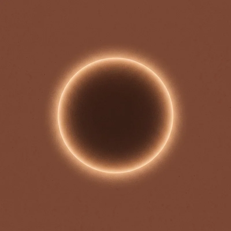 The Ground tile — a warm amber glowing ring on deep ember brown.